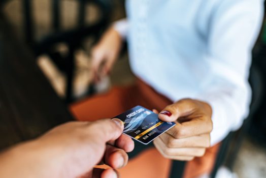 woman handing over a credit card
