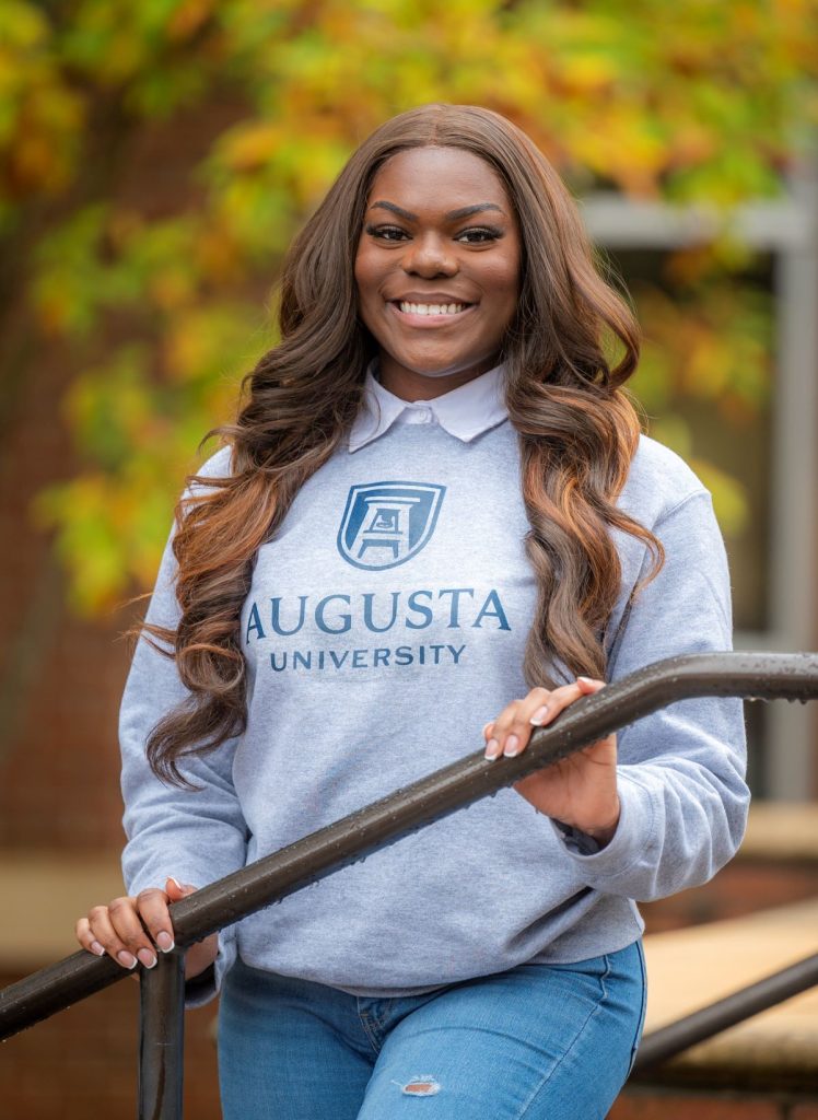 woman wearing grey Augusta University sweater