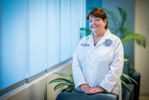Woman in white coat smiling