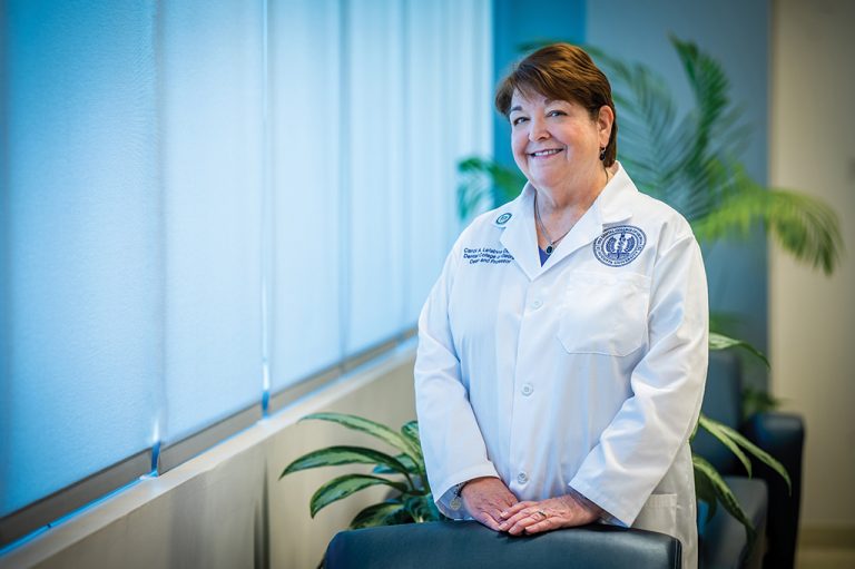 Woman in white coat smiling