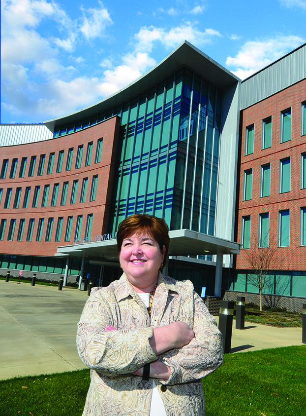 Woman smiling in front of a building