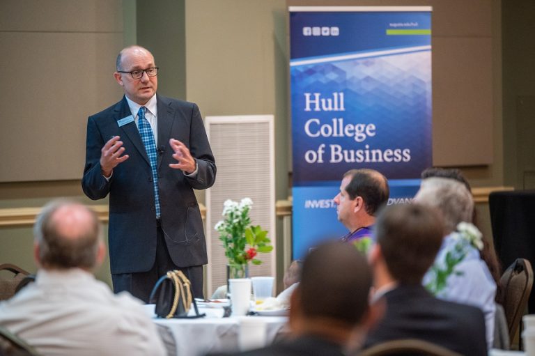 Man speaking to a gathering of others