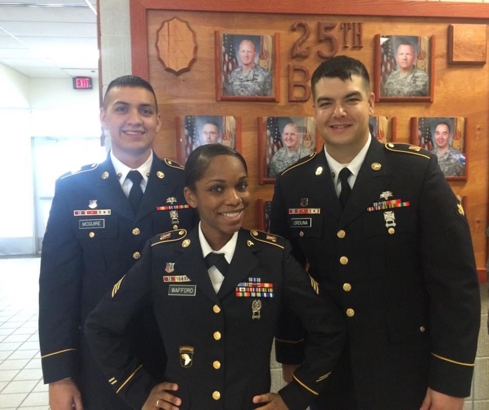 two men and a woman in Army formal uniform