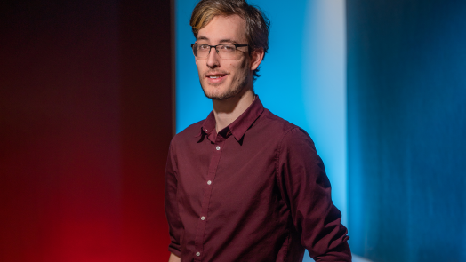 man smiling in red shirt