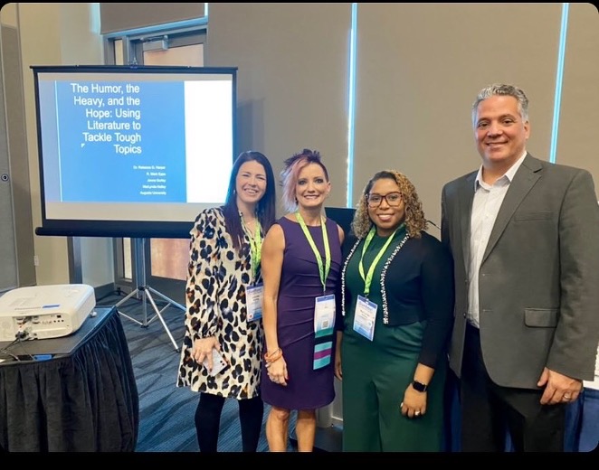 three woman and a man at a conference