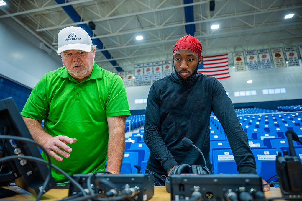 Two men talking near equipment