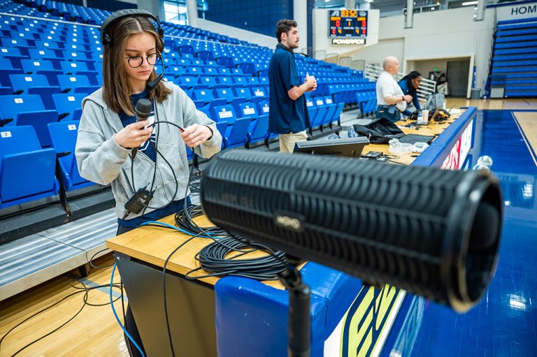 Woman, men working with equipment