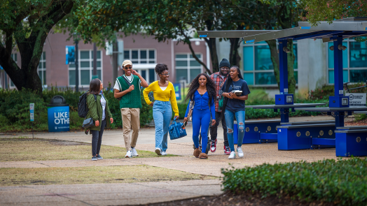 Five students walking outside on the Health Sciences Campus at Augusta University.