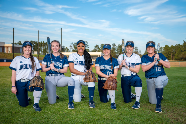 Softball players on field with equipment