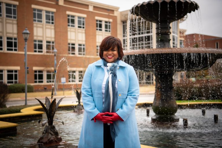 woman standing by a fountain