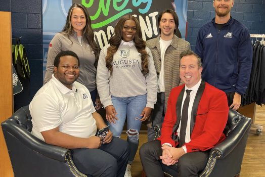group of people in front of sign in campus store