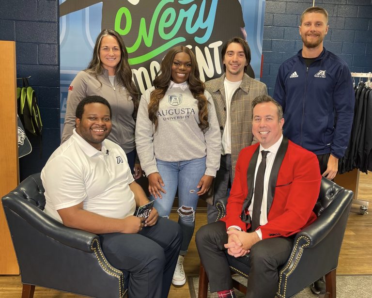 group of people in front of sign in campus store