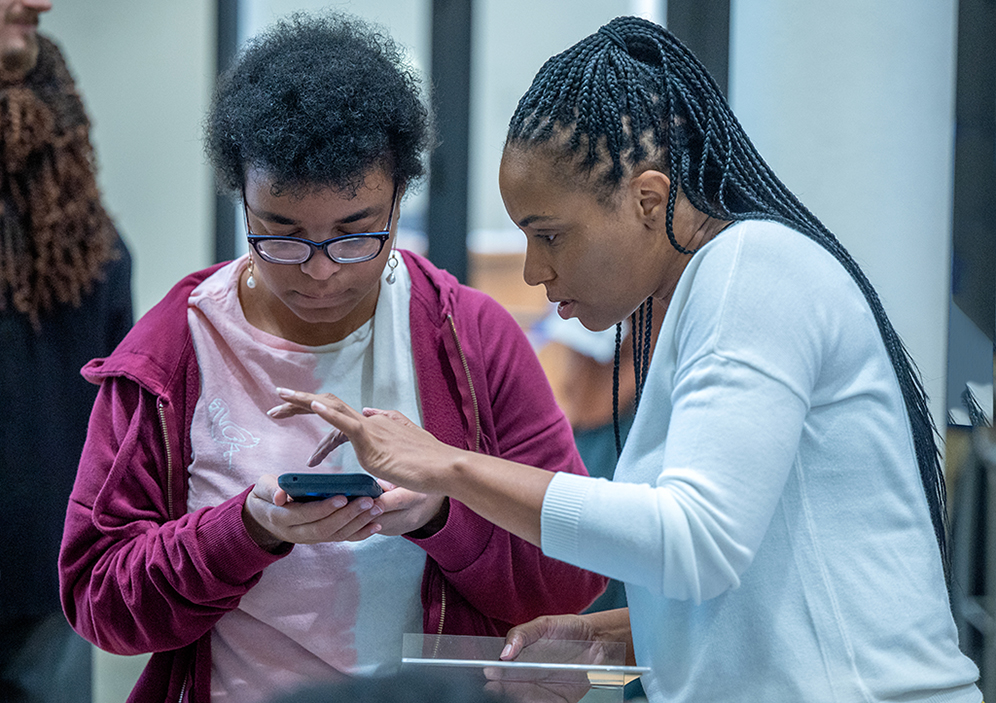 Two people looking at a phone