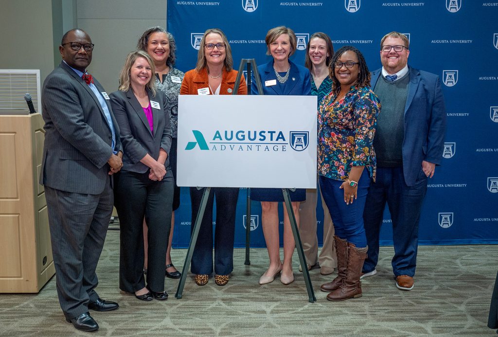 Group of people with Augusta Advantage sign
