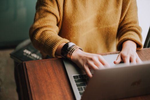 person typing at a computer