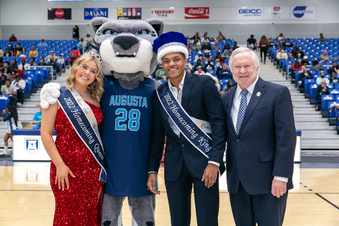 Homecoming queen and king with university president and jaguar mascot