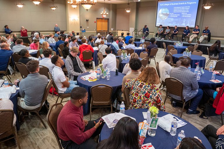 People sitting in a room listening to a presentation