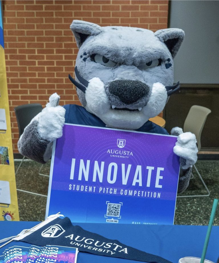 Jaguar mascot holding a sign