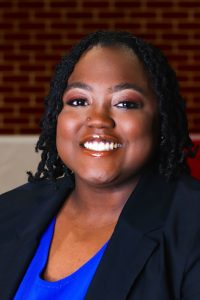 woman wearing a blue blouse and black blazer