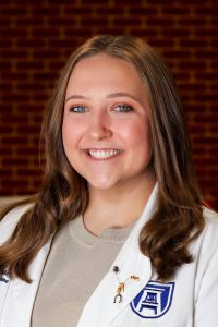 woman wearing white coat and beige shirt