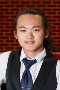 man smiling with vest and tie