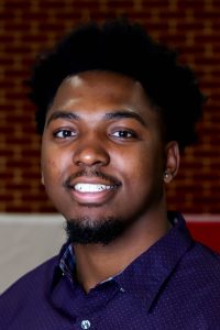 man wearing a purple shirt