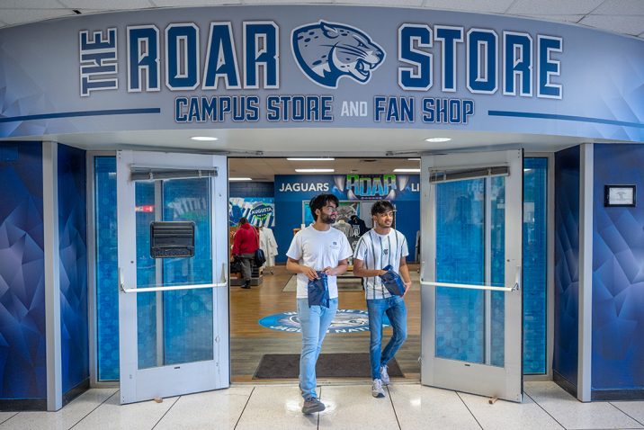 Two men walking out of Roar Store