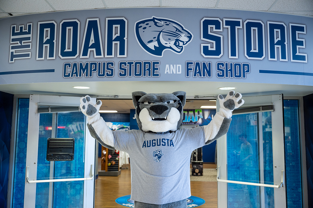 Mascot Augustus in front of the Roar Store