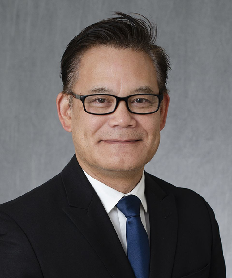 man with glasses wearing a suit and tie