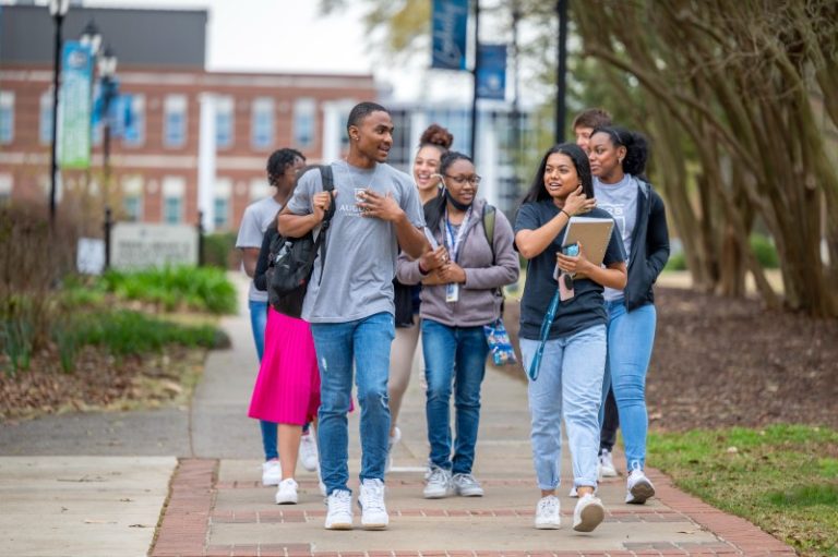 Group of college students walking outside on campus