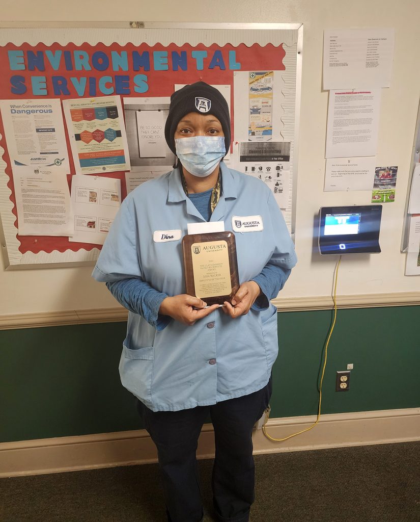 woman standing with an award
