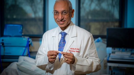 Dr. Satish Rao holding vibrating capsule