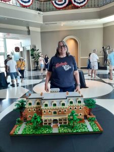 woman standing in front of a Lego creation