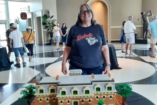 woman standing in front of a Lego creation