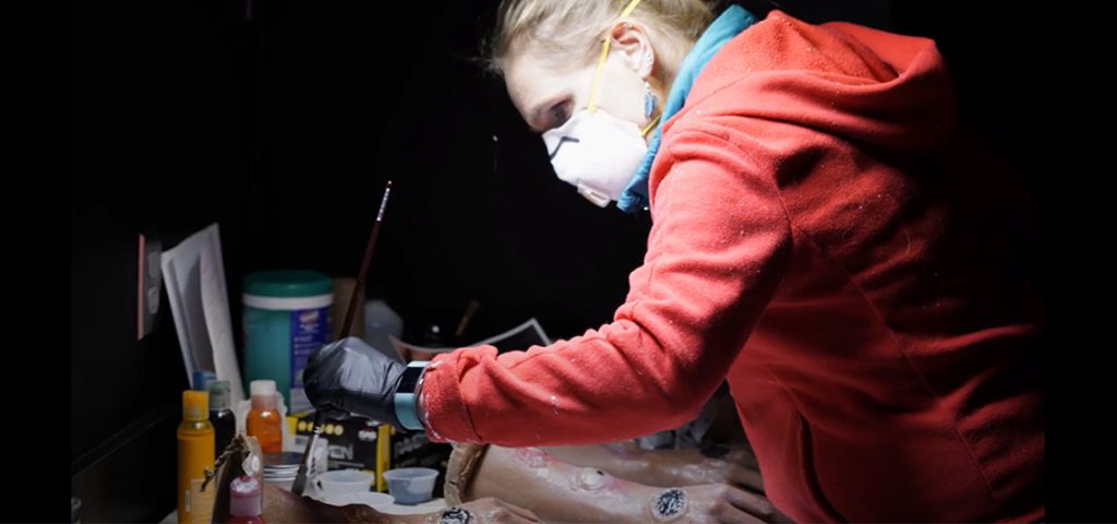 woman designing medical illustrations with a mask on