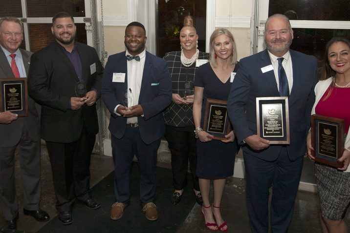 Award recipients from 2022, standing holding awards