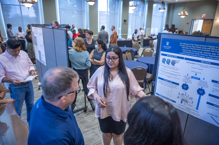 young women presenting to a few people