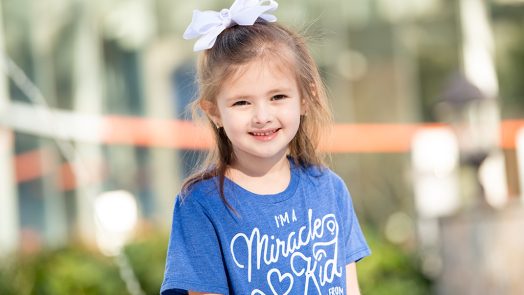 Little girl in blue t-shirt smiling