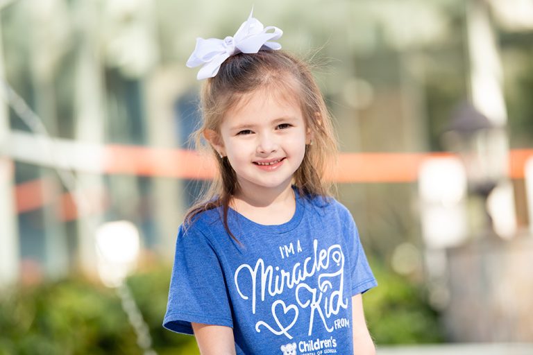Little girl in blue t-shirt smiling