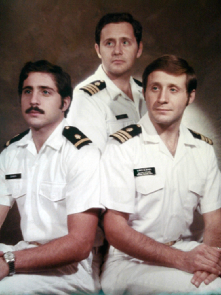 three men in navy uniforms