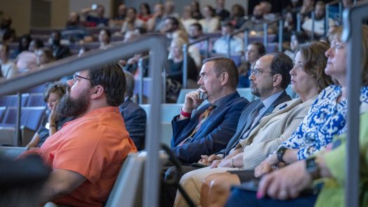 men and women listening in an auditorium