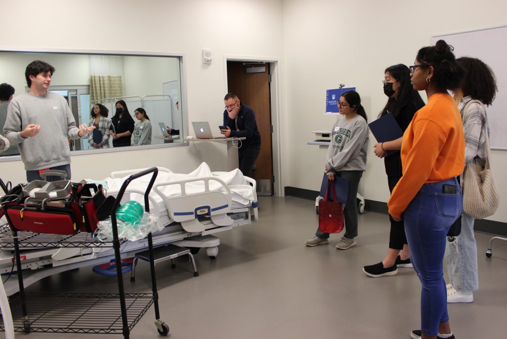 Medical students teaching younger students in a simulation center