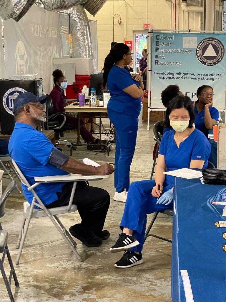 nursing student takes the blood pressure of a gentleman