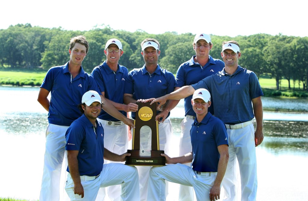 golf team holds a national championship trophy