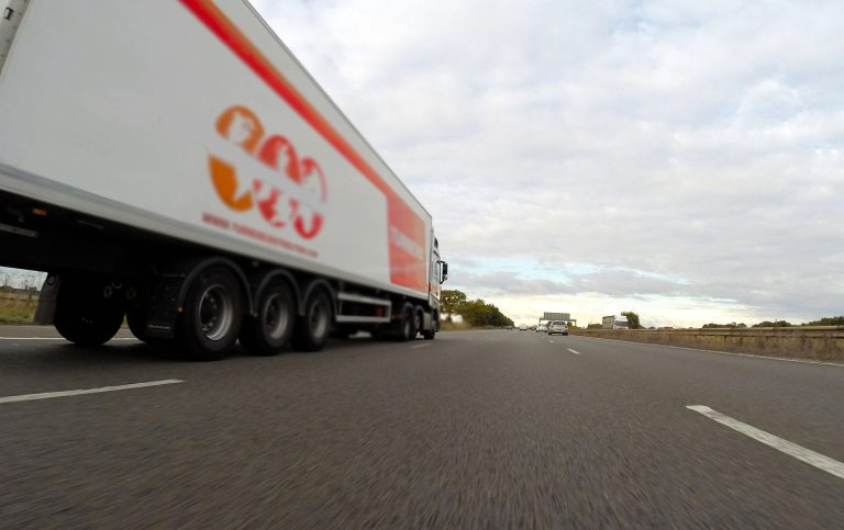 Semi-truck going down road