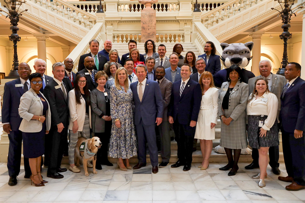 large group of people standing in a large room