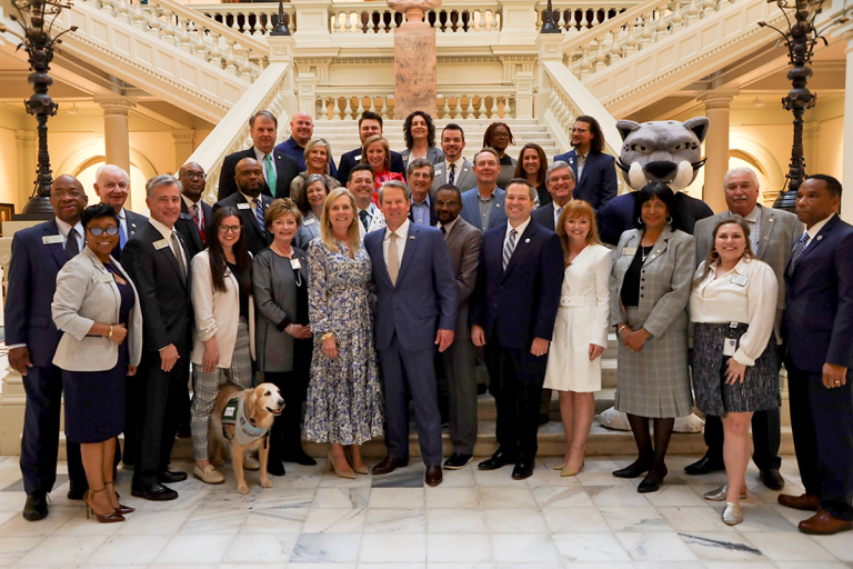 large group of people standing in a large room