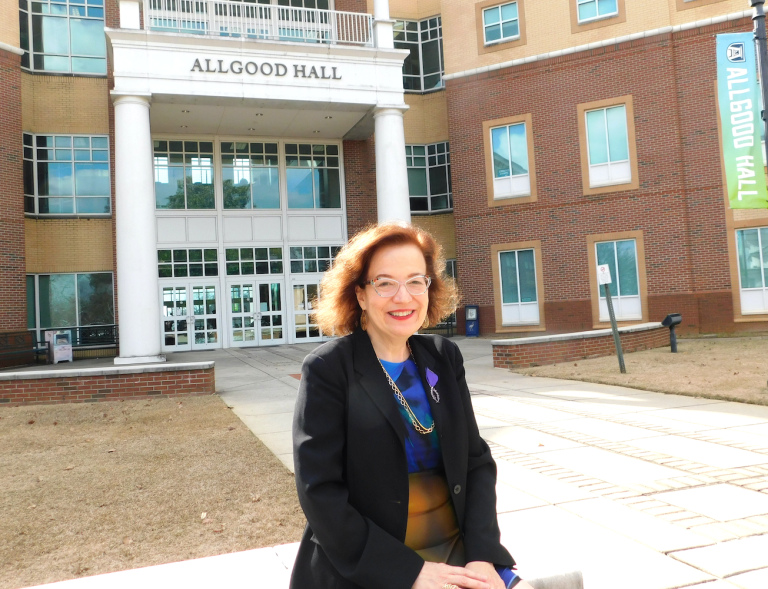 Professor sitting in front of Allgood Hall