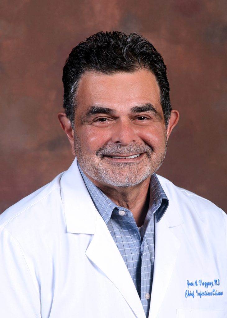 Man smiling in a white coat