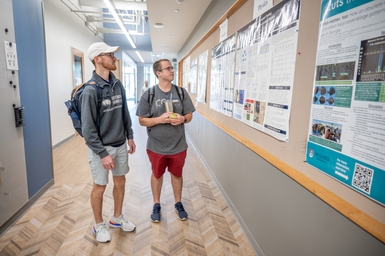 Two male students in a hallway
